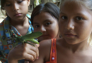 girls posing with grasshopper puerto esperanza peru