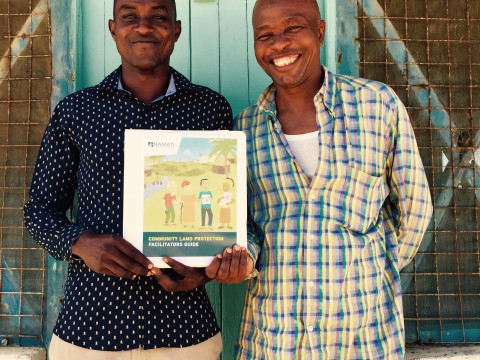Kenya Land Alliance community facilitators in Tana River, Yusuf Omar Uleta and Odha Ilu Hiyesa, with Namati’s new Community Land Protection facilitator’s guide. Image courtesy of Namati.
